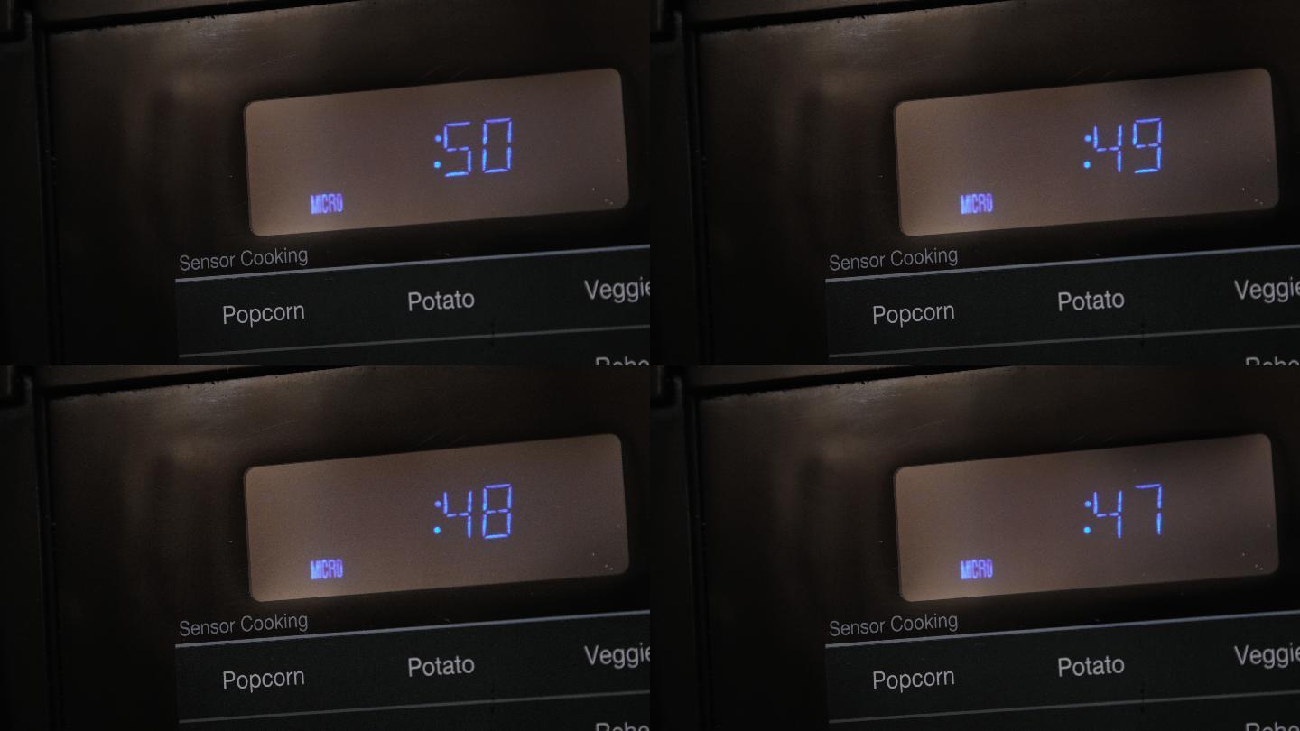 在黑色数字显示微波炉上倒计时烹饪时间