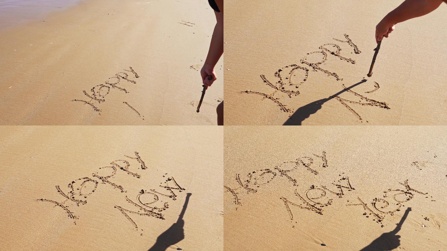 在沙滩上写新年美女写字国外度假海边游玩