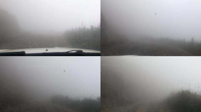 恶劣天气大雾汽车行驶在山路上