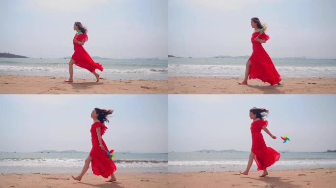 红衣美女赤脚走在海滩上