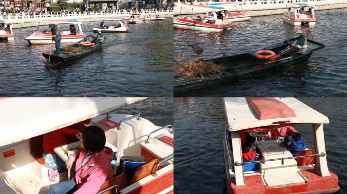 北京后海公园湖中水草清理人员开船经过