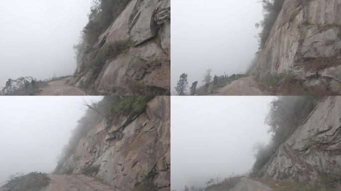 汽车行驶在能见度低的悬崖峭壁山路上