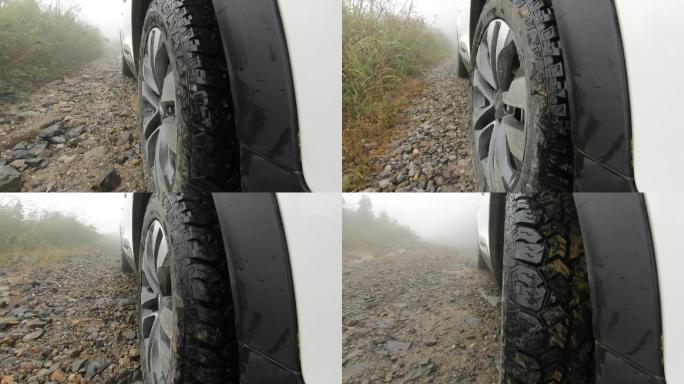 汽车行驶在下雨山路上 轮胎特写