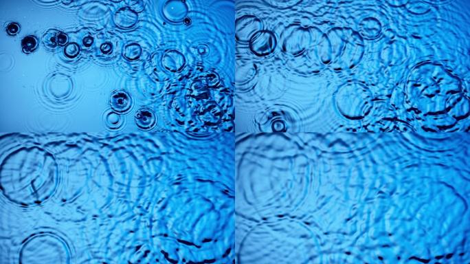 水滴在蓝色水面上形成圆圈
