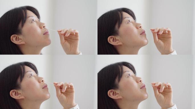 新冠疫情都市白领拿棉签居家自测病毒抗原