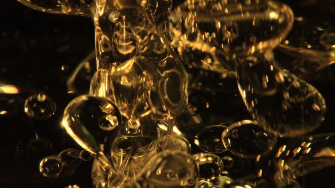 金黄色泡沫油滴金色液体漂浮上升广告空镜