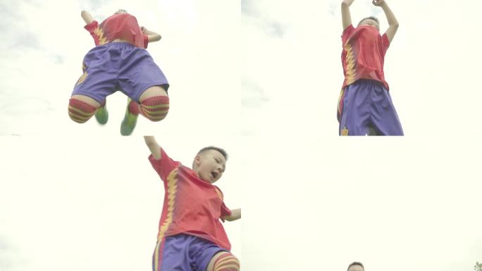 小孩学生运动员跳起庆祝胜利比赛冠军肢体