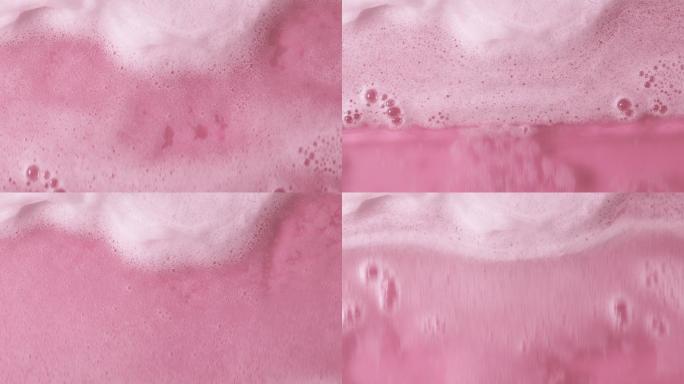 带有泡沫的粉红色水面俯视图。
