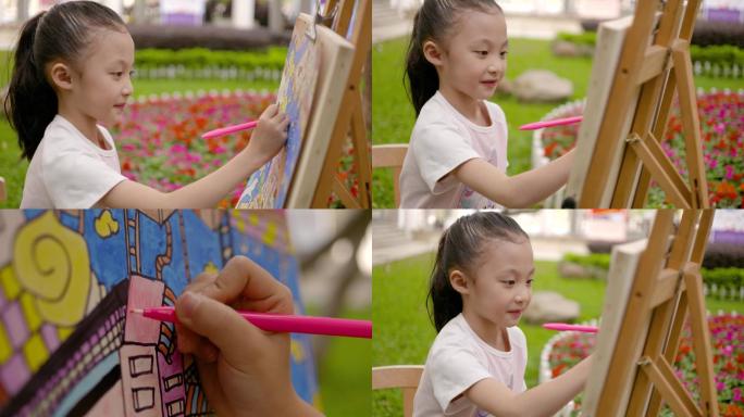 可爱小女孩户外画画描绘幸福社会房地产素材