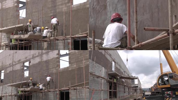 建筑工人瓦工正在往楼房上抹水泥