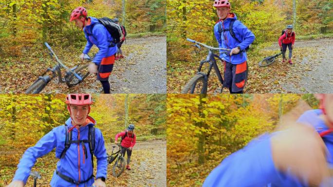 年轻男女从森林地面上扶起山地自行车