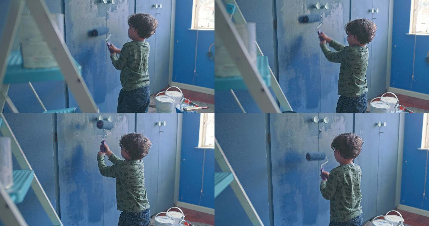 可爱的小男孩在家里粉刷墙壁