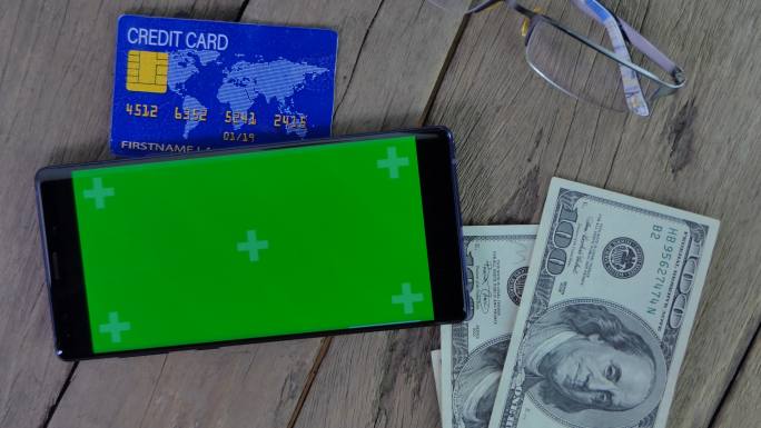绿色屏幕的手机美元港币数钱