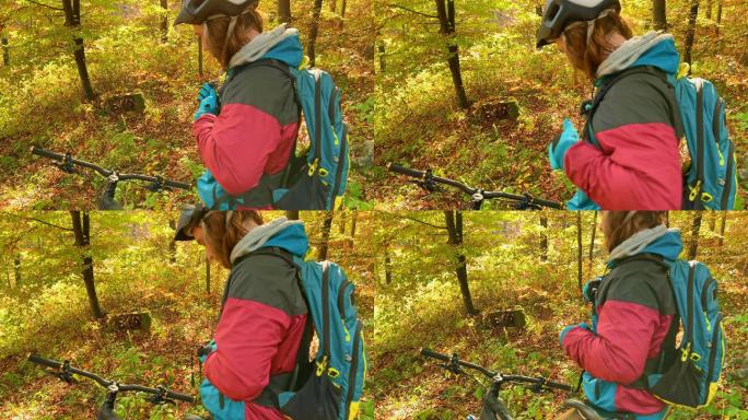 年轻人在骑山地车进入森林之前调整背包