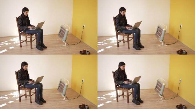 一名女子在空荡荡的公寓里使用笔记本电脑