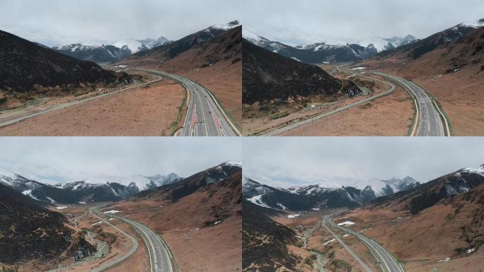 雪山公路视频蜿蜒前行雪山谷底高速公路