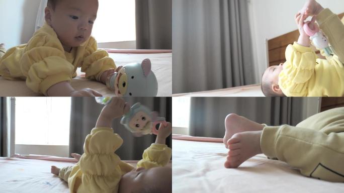 婴儿玩玩具在床上躺着玩