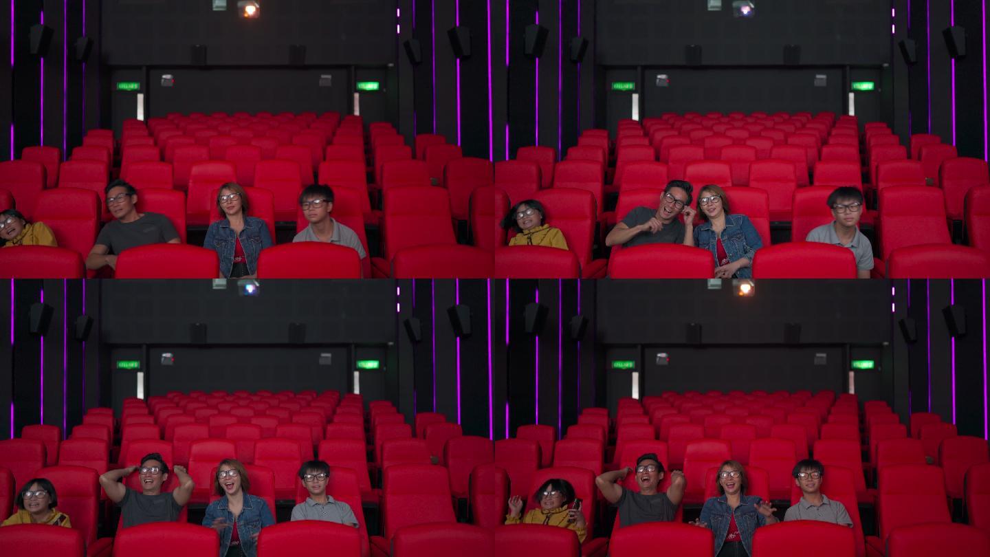 一个家庭戴着3D眼镜在电影院看3D电影