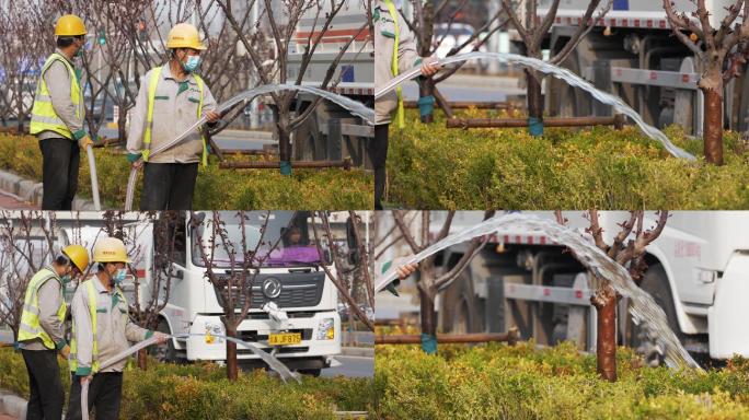 环卫工人给路边花草浇水