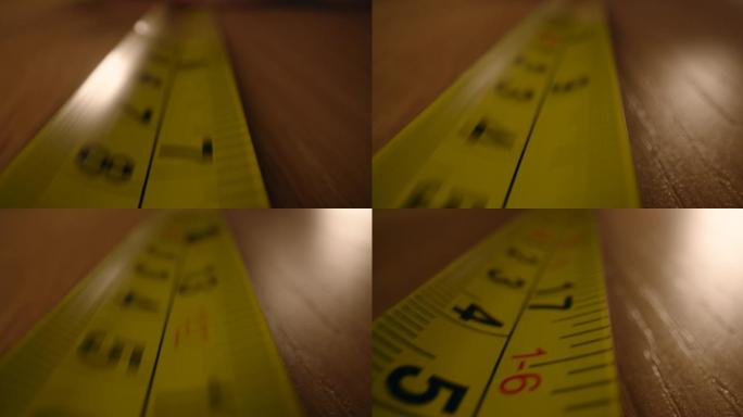 运动中的卷尺卷黄色尺子测量桌子长宽测量测