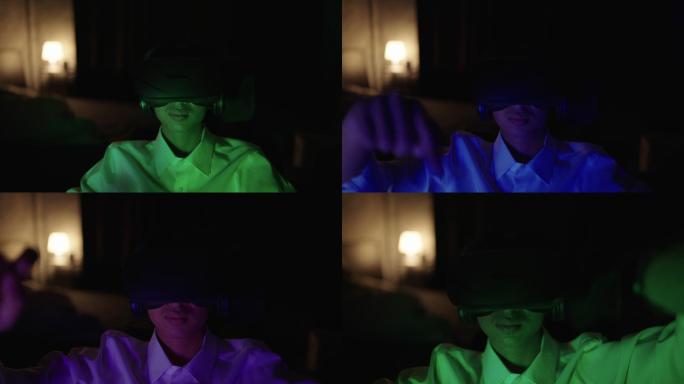 年轻人晚上使用虚拟现实眼镜玩游戏