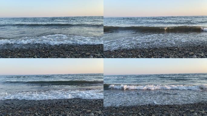 日落时分的海边鹅卵石沿岸海平面