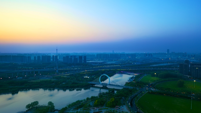 郑州蝶湖公园戒指桥航拍延时日转夜4k素材