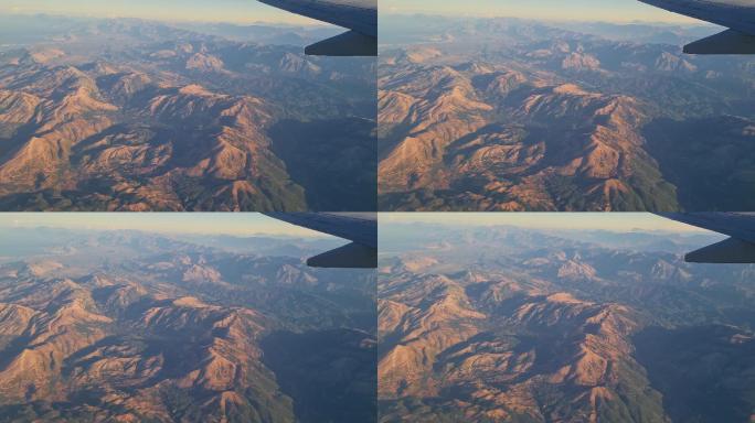 在飞越陡峭的山脉时，通过飞机窗口观看