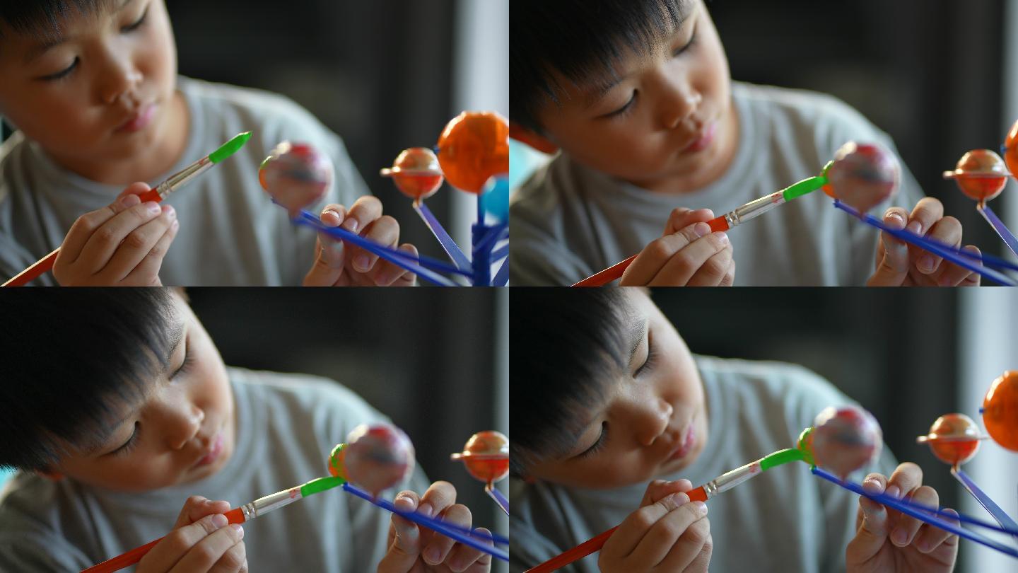 男孩画太阳系模型专注创作航空航天梦想