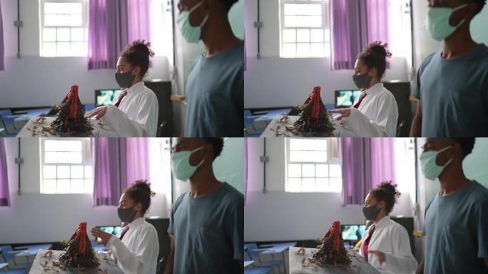 学生们在教室里用口罩做关于火山的演示