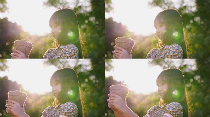 可爱的小女孩拿着小植物