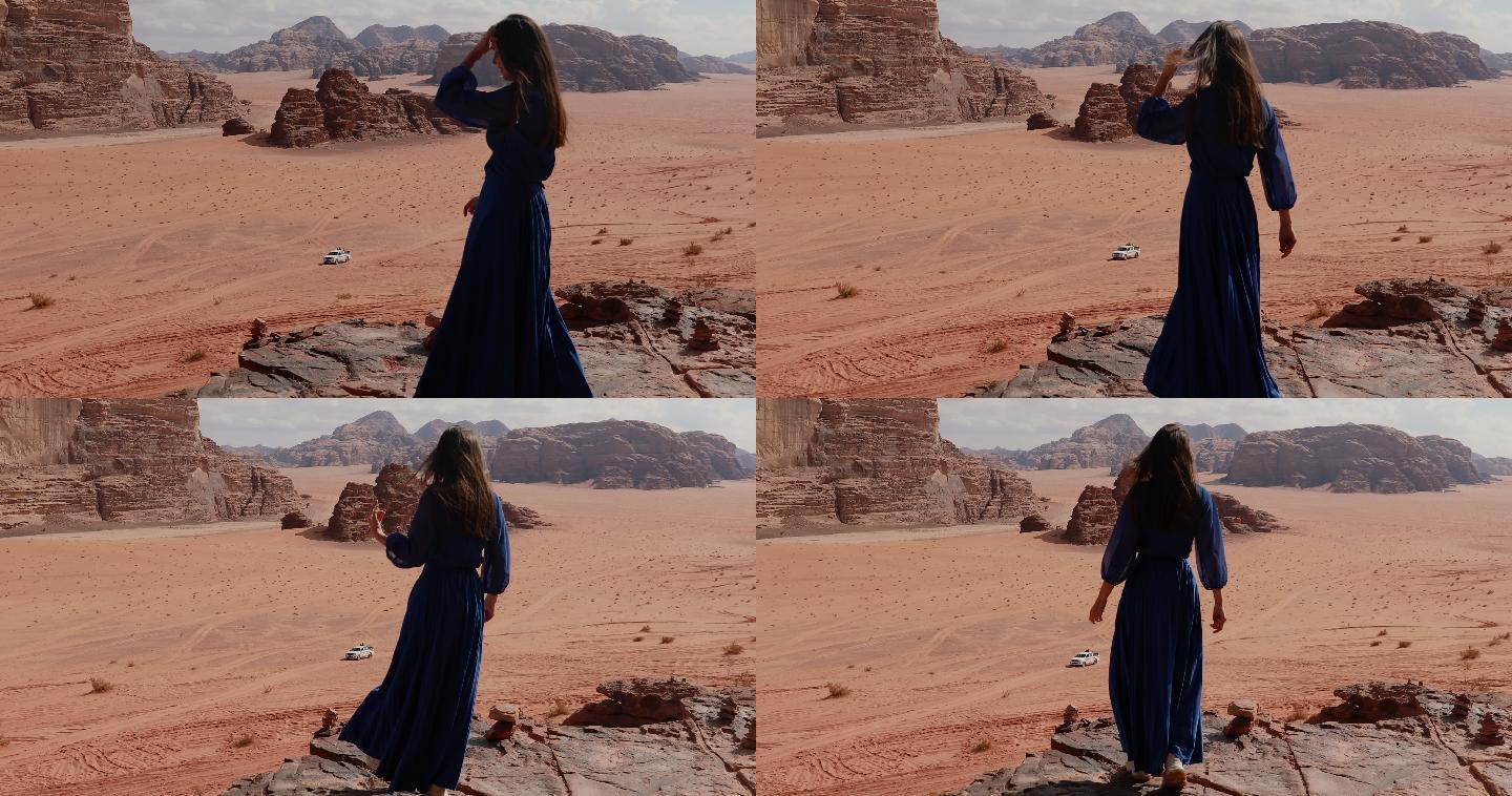 女子凝视着瓦迪朗姆沙漠的风景