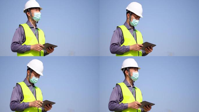 年轻工程技术人员在现场使用平板电脑核查