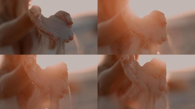 意大利，超级慢镜头：女人的手在玩沙子。