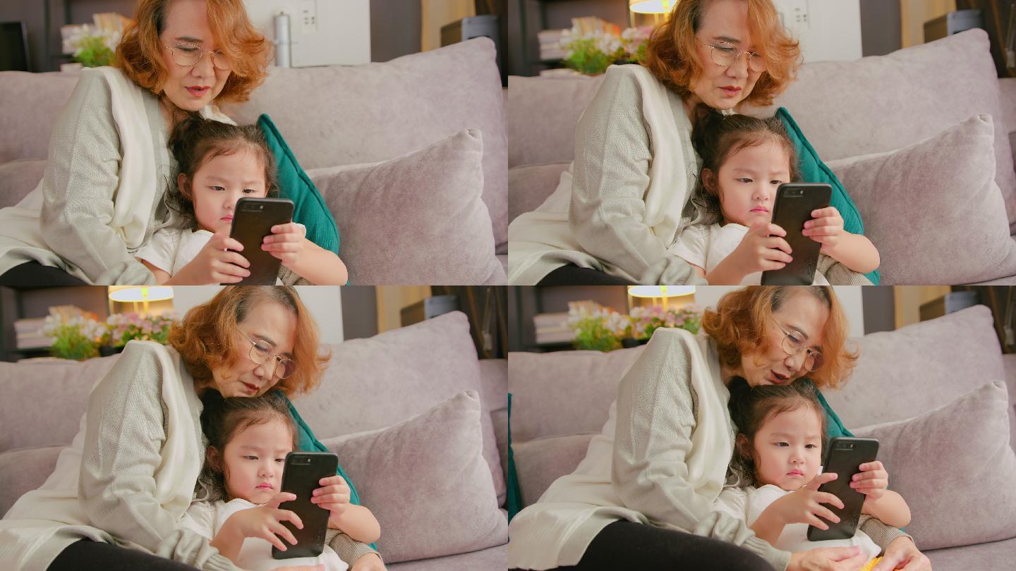 奶奶和孙女一起看动画片。