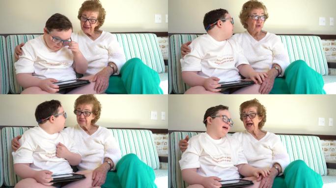 男孩与祖母一起使用平板电脑