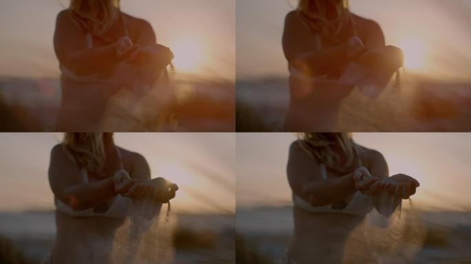 意大利，超级慢镜头：女人的手在玩沙子。