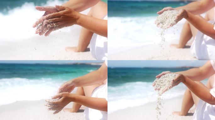 意大利，女子手玩沙子的慢镜头。