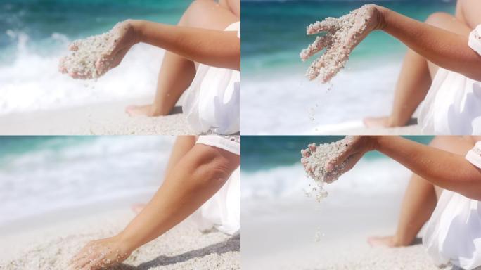 意大利，女子手玩沙子的慢镜头。