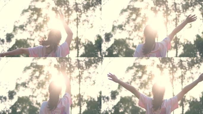夕阳下女孩向太阳挥舞双手视频素材