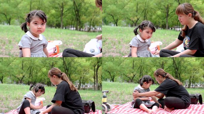 陪女儿在公园玩耍的母亲