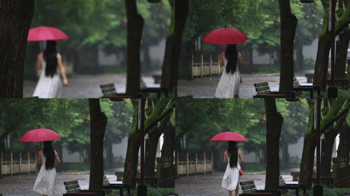 江南雨天穿白裙子女孩戴着红雨伞漫步背影
