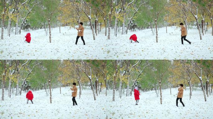 在公园里打雪仗的一对中国母女