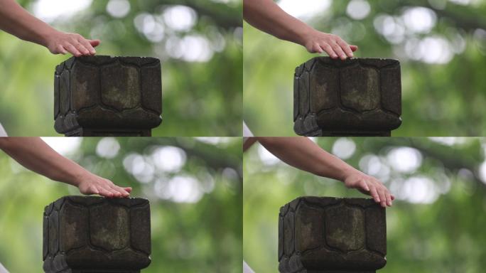 江南雨天女孩手滑过划过抚摸石柱护栏特写