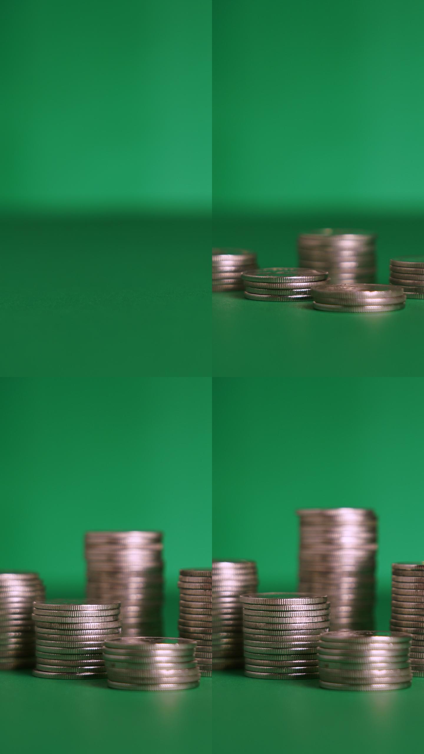 绿色背景上堆叠硬币的垂直镜头