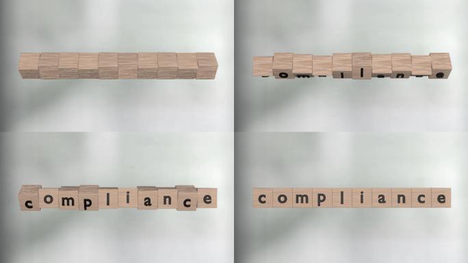 立方体上的字母构成单词Compliance。前面是散焦的背景。