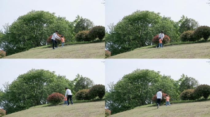 4K春天草地上爸爸和儿子玩耍