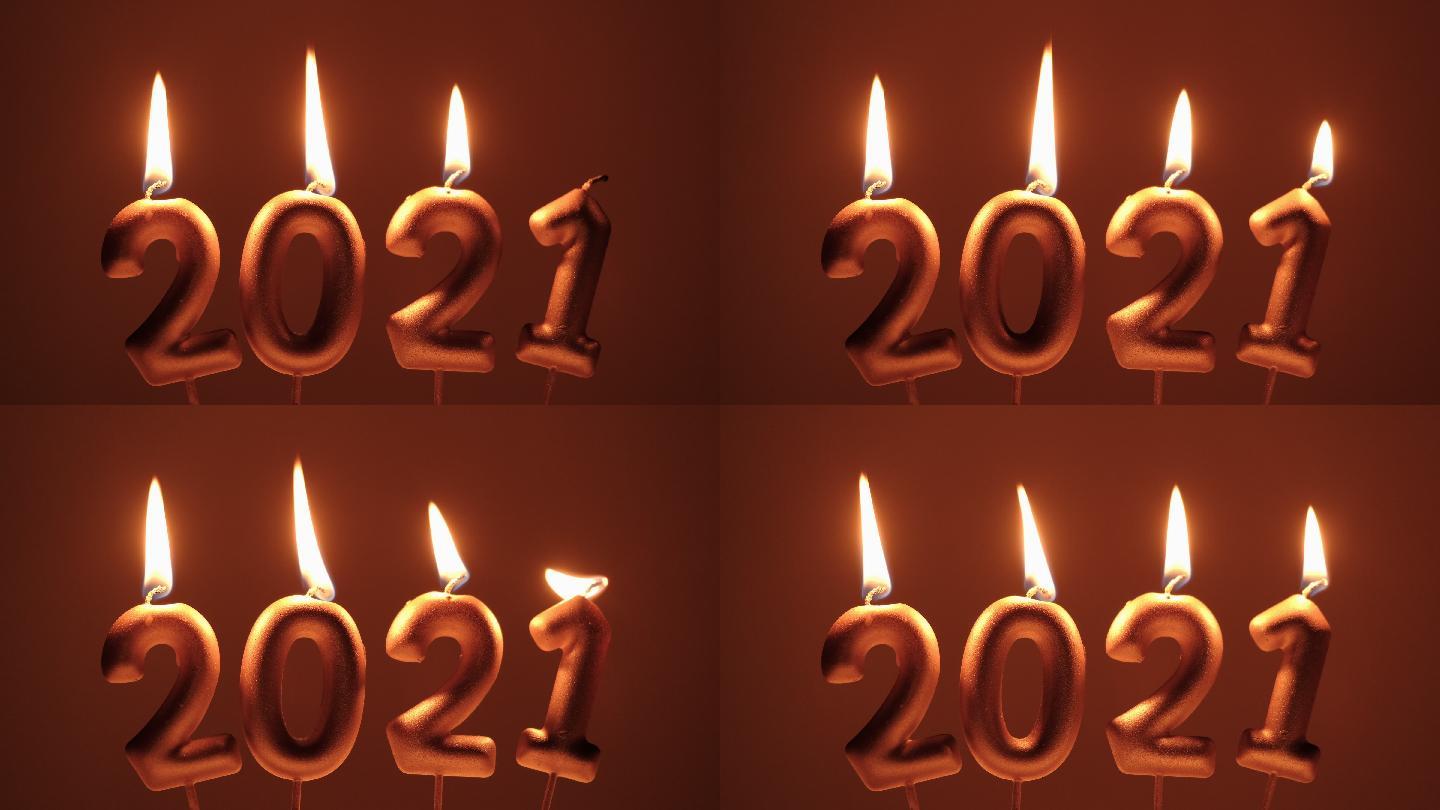 2021蜡烛新年快乐燃烧火焰在黑暗的背景。希望之年