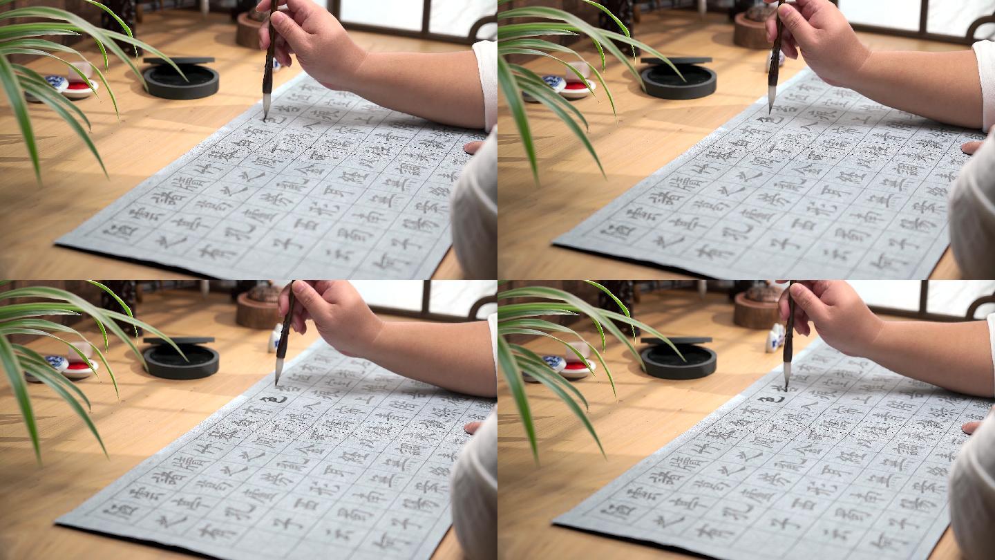 用字帖练习毛笔字的亚裔男性手部特写