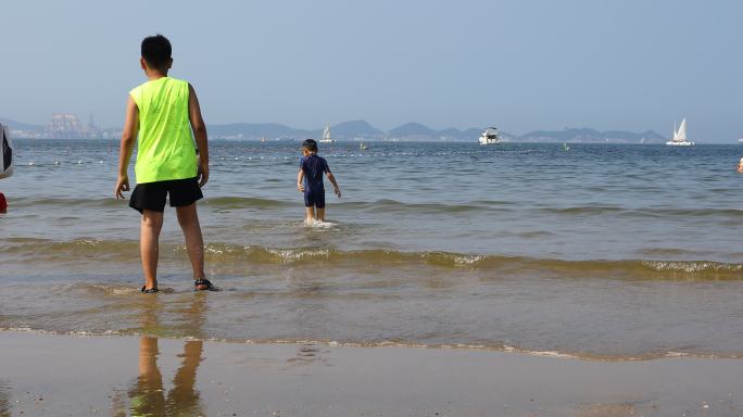 海边沙滩玩水的孩子素材